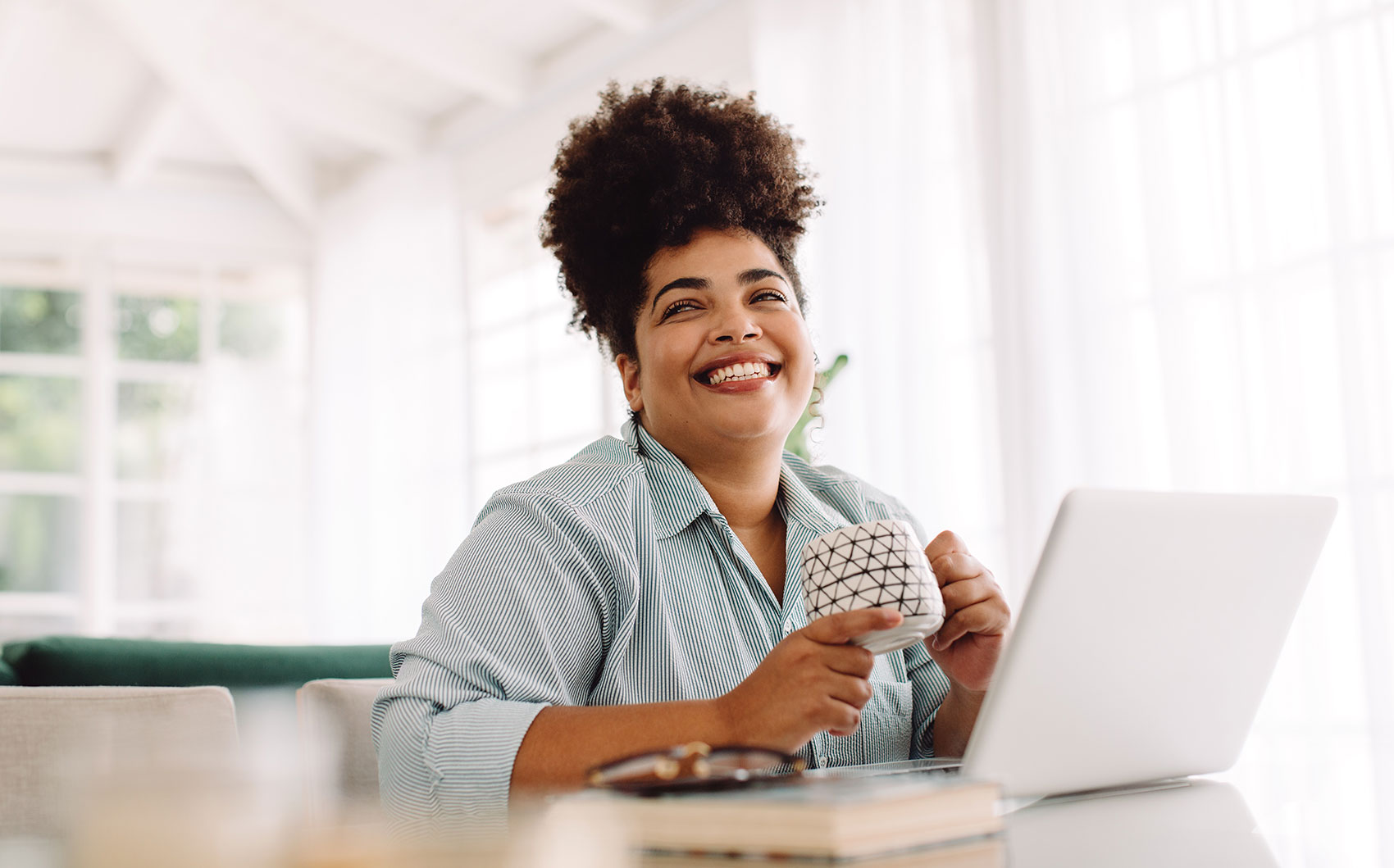 Woman Smiling At Desk With Coffee