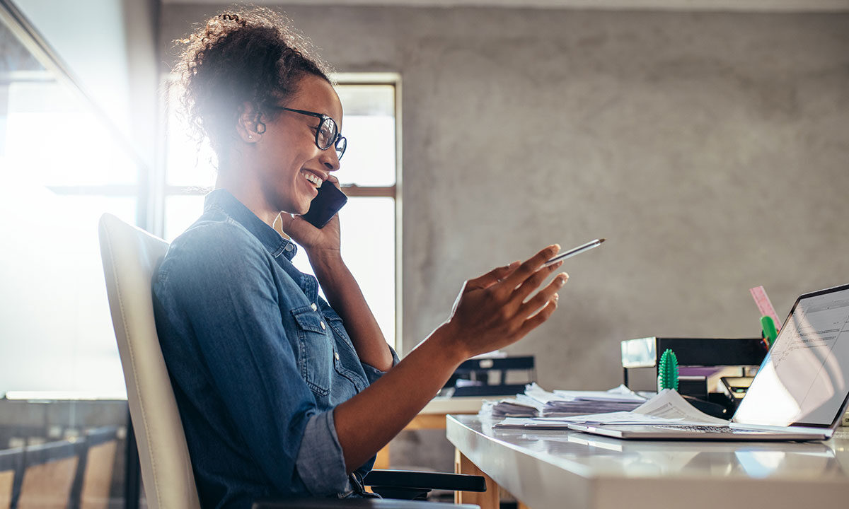 Small business owner sending a personal follow-up message to an existing client from a laptop.