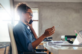 Small business owner sending a personal follow-up message to an existing client from a laptop.