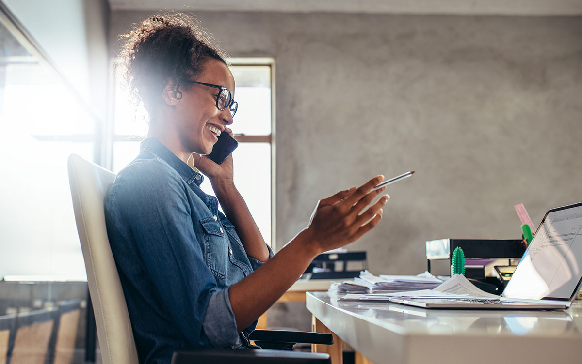 Small business owner sending a personal follow-up message to an existing client from a laptop.