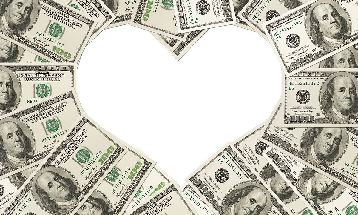 One hundred dollar bills arranged in the shape of a heart
