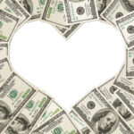 One hundred dollar bills arranged in the shape of a heart