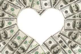 One hundred dollar bills arranged in the shape of a heart