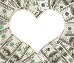 One hundred dollar bills arranged in the shape of a heart