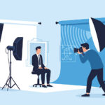 Illustration of a headshot studio with softbox lighting, a seated subject in a suit, and a photographer